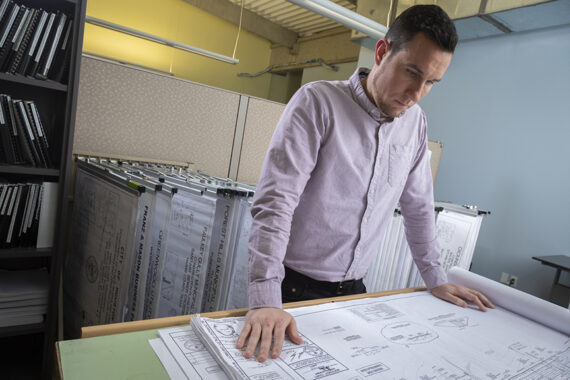 Engineer reviewing blueprints on a desk