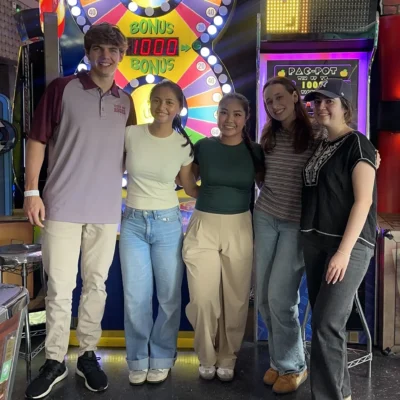 5 interns in front of arcade machines