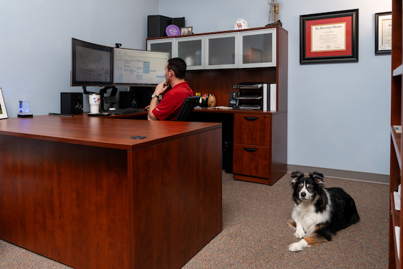 A&S employee in office with dog